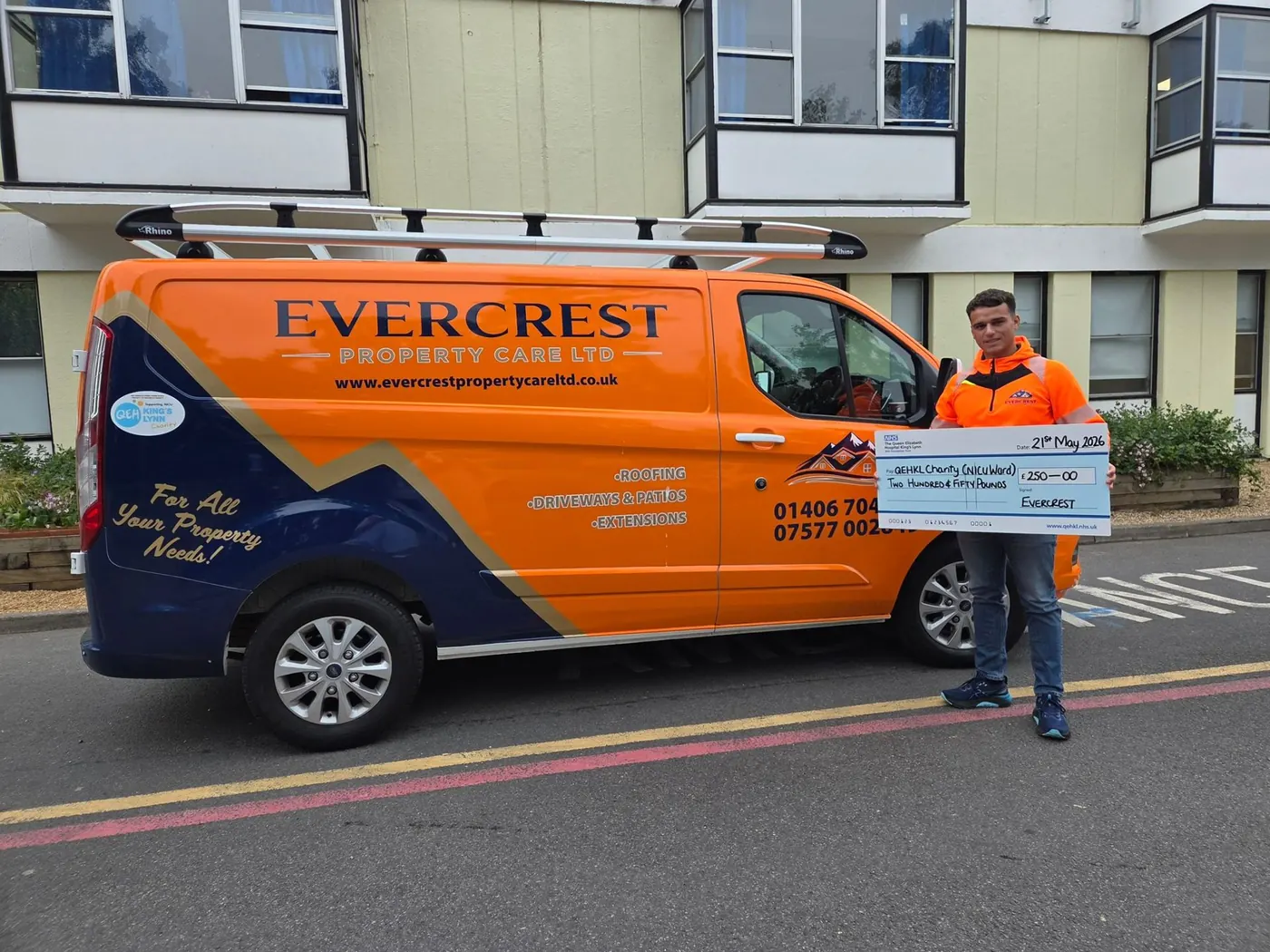 Fred from Evercrest Property Care presenting a £250 charity cheque to QEH King's Lynn NICU Ward beside the branded company van